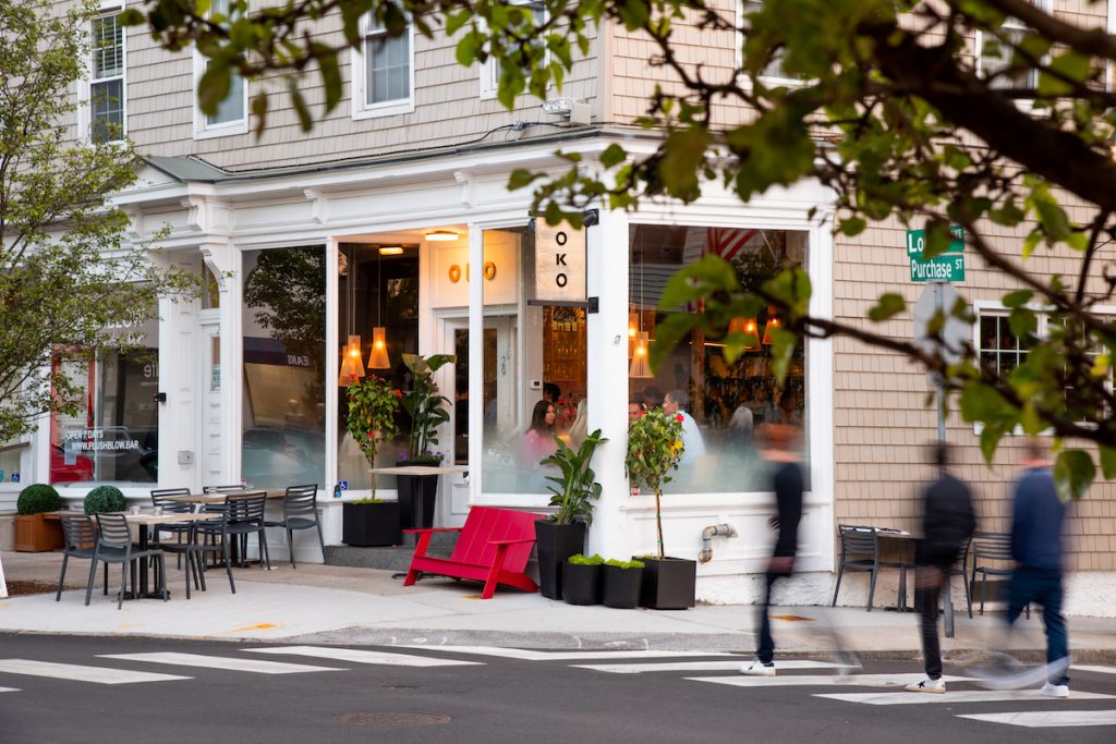 OKO restaurant exterior with outdoor seating, pictured from across the street.