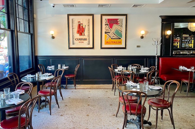 Ruby's interior with round tables and red chairs