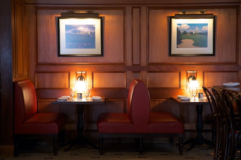 Dimly lit Rye Bar & Grill interior with booths.
